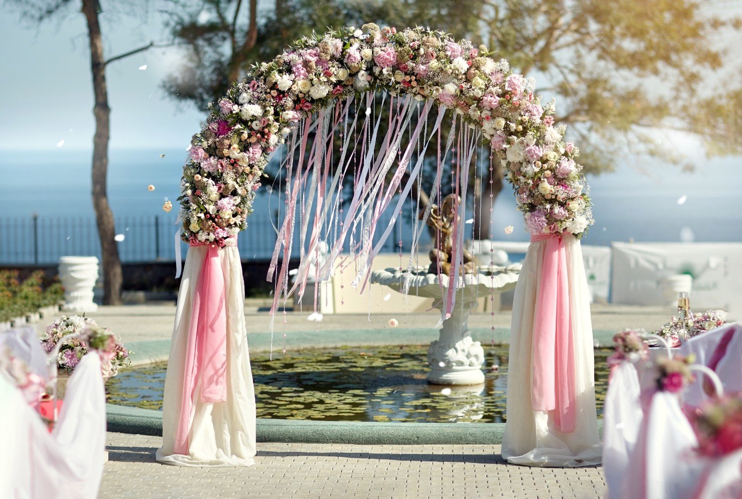 wedding-arch-ribbons-flowers-against-sea (1)